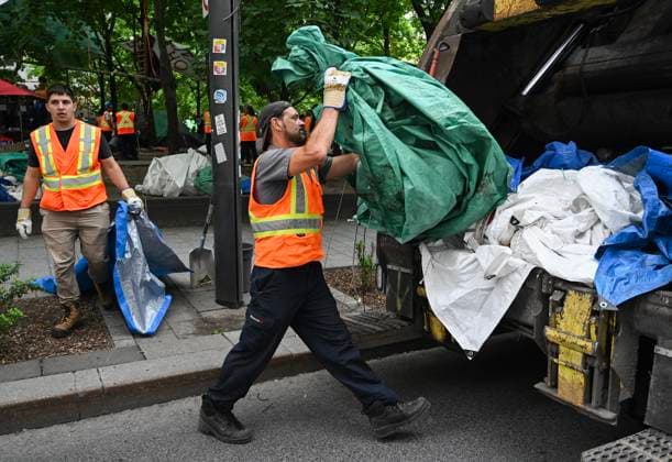 July 5, 2024, Montreal, Pq, Canada: City workers load tents into a garbage truck after police cleared a pro-Palestine protest encampment in Victoria Square in Montreal, Friday, July 5, 2024. Montreal Canada  - ZUMAc35_ 20240705_zaf_c35_025 Copyright: xGrahamxHughesx