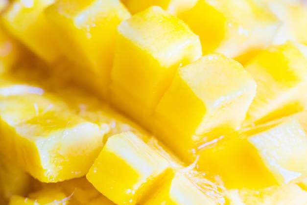Close up view of ripe mango fruit sliced into cubes. Soft focus, can be used as food background ,model released, Symbolfoto