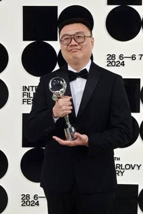 Chinese director Zhengfan Yang poses in front the photo wall with his Grand Prix of the Proxima Competition for his film The Stranger after the closing awards ceremony of the 58th Karlovy Vary International Film Festival, in Karlovy Vary, Czech Republic, on July 6, 2024. (CTKxPhoto SlavomirxKubes) CTKPhotoP2024070605660  CTKPhotoP2024070605660