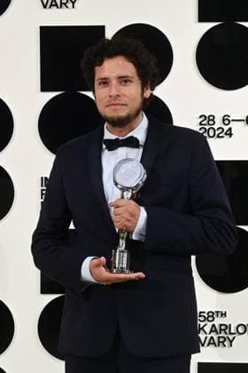 Peruvian director Paolo Tizon poses in front the photo wall with his Proxima Special Award for his documentary When the Night Came after the closing awards ceremony of the 58th Karlovy Vary International Film Festival, in Karlovy Vary, Czech Republic, on July 6, 2024. (CTKxPhoto SlavomirxKubes) CTKPhotoP2024070605743  CTKPhotoP2024070605743