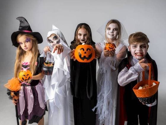 Group of children in costumes holding sweets at Halloween party. Group of children at Halloween party ,model released, Symbolfoto