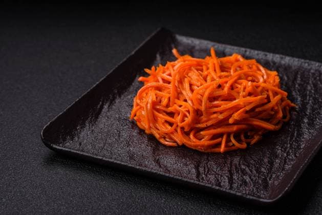 Tasty spicy Korean carrot with spices and herbs on a dark concrete background Tasty spicy Korean carrot with spices and herbs on a dark concrete background. Asian food Copyright: xZoonar.com TetianaxChernykovax 21860822