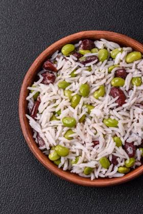 Delicious white cooked rice with green edamame beans with salt and spices Delicious white cooked rice with green edamame beans with salt and spices. Asian cuisine dish Copyright: xZoonar.com TetianaxChernykovax 21897151