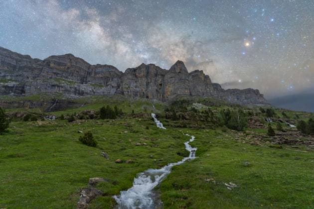 MR_ID22586_17761_JuanLopez.jpg A stunning nighttime view of the Milky Way galaxy shining over the rugged cliffs and a serene flowing stream in Pueblo de Sotres, Asturias, Spain. Perfect for illustrating natural beauty and tranquility. Model Released JuanLopez_ID22586_658771_002 Copyright: xJuanxLopezx RECORD DATE NOT STATED