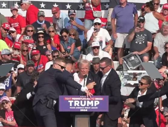 (240714) -- BUTLER, July 14, 2024 -- This video screenshot shows former U.S. President Donald Trump being helped off the stage at a rally in Butler, Pennsylvania of the United States after what sounded like gunshots rang out through the crowd, July 13, 2024. Video footage showed that Trump was making a speech when popping sounds rang out over the rally. Screams could be heard in the crowd, and Trump was swiftly escorted off the stage by Secret Service agents. Blood could be seen on the side of his head and his ear. He was quickly escorted into a vehicle, and his motorcade has left the venue. Trump is currently safe and is expected to survive, NBC News reported, quoting senior law enforcement officials. The shooting incident at Trum 