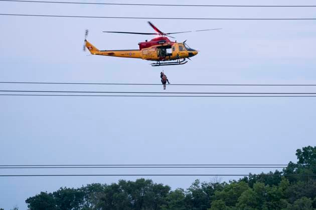 July 16, 2024, Toronto, On, Canada: A Royal Canadian Air Force Search and Rescue helicopter crew rescues a man from Etobicoke Creek following heavy rain in Toronto on Tuesday, July 16, 2024. Torrential rain that pummelled Toronto flooded a major highway, several thoroughfares and a key transit hub on Tuesday öÄÃ¬ requiring emergency crews to rescue people from stranded cars and other spaces öÄÃ¬ while large parts of the city were left without power. Toronto Canada  - ZUMAc35_ 20240716_zaf_c35_148 Copyright: xArlynxMcadoreyx