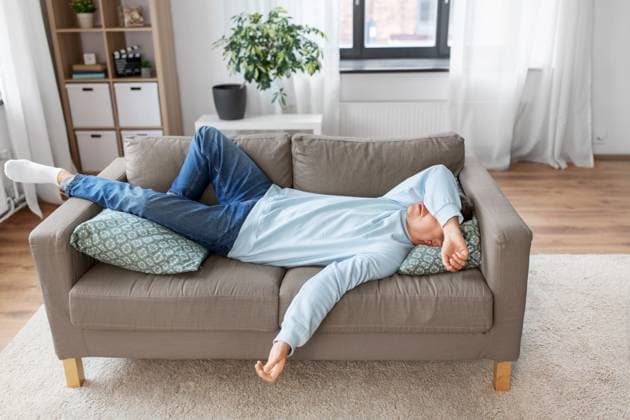 people, boredom and depression concept - bored or lazy young man lying on sofa at home. bored or lazy young man lying on sofa at home ,model released, Symbolfoto