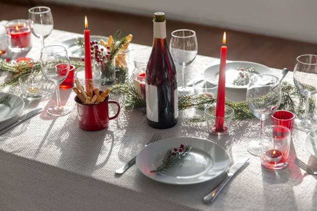 winter holidays, dinner party and celebration concept - christmas table serving with candles, crockery and wine at home. christmas dinner party table serving at home ,model released, Symbolfoto