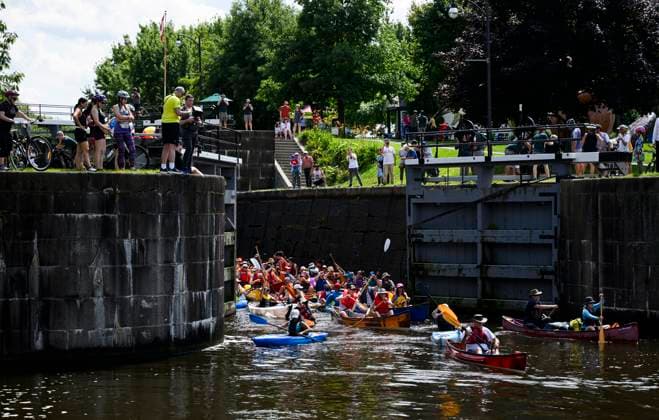 July 20, 2024, Ottawa, On, CAN: People watch as paddlers exit the locks at Hartwells Lockstation during Lock & Paddle 2024 on the Rideau Canal in Ottawa, on Saturday, July 20, 2024. A flotilla of canoes and kayaks descended and ascended the locks to celebrate Parks Day on the Rideau Canal, a UNESCO World Heritage site. Ottawa CAN  - ZUMAc35_ 20240720_zaf_c35_032 Copyright: xJustinxTangx
