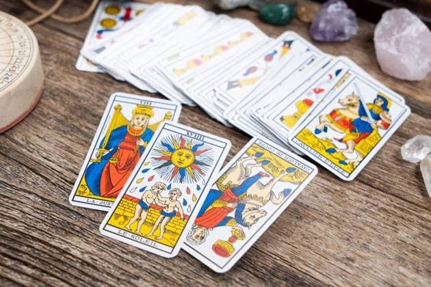 Fortune telling on tarot cards lifestyle, used Marseille Tarot deck by unknown artist published first in 1709. Fortune telling on tarot cards ,model released, Symbolfoto