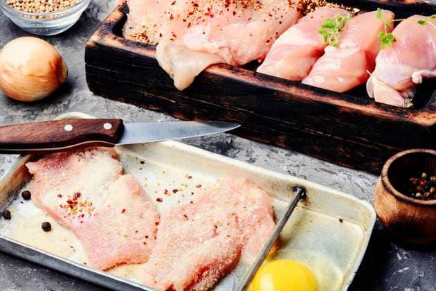 Raw chicken steaks on a kitchen board.Cooking ingredients. Raw chicken breast ,model released, Symbolfoto