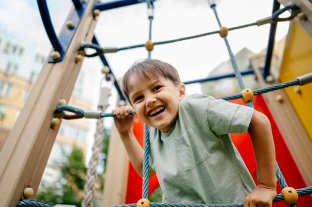 Creative Highlights Symbolfotos Happy boy playing at playground model released, Symbolfoto, ANAF03252