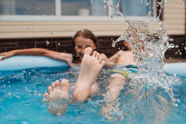 Creative Highlights Symbolfotos Happy sibling splashing water in pool at back yard model released, Symbolfoto, ANAF03316