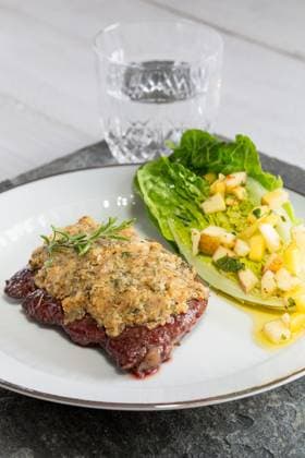 Beef steak with mustard herb crust and romaine lettuce hearts with mango apple vinaigrette.. Beef steak with mustard herb crust and romaine lettuce hearts with mango apple vinaigrette ,model released, Symbolfoto