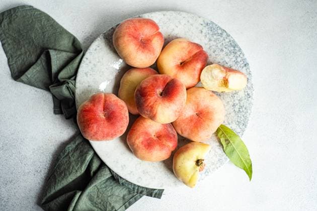 Ripe fresh flat peaches in the bowl Tbilisi, Tbilisi, Georgia R_LSQHTY240722-1492817-01
