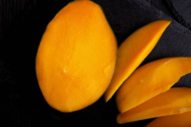 Ripe egyption Mango slices served at black dish. close up ,model released, Symbolfoto