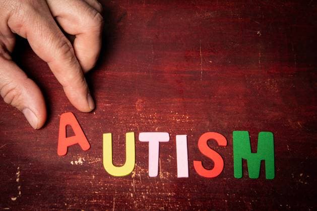 AUTISM. Health and acceptance concept. Text on a wooden background. Copyright: xEdgarsxSermulisx