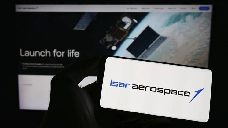 Stuttgart, Germany, 04-02-2023: Person holding mobile phone with logo of company Isar Aerospace Technologies GmbH on screen in front of business web page. Focus on phone display, Europe *** Stuttgart, Germany, 04 02 2023 Person Holding Mobile Phone With Logo of Company Isar Aerospace Technologies GmbH ON Screen in Front of Business Web Page Focus ON Phone display, Europe Copyright: imageBROKER TimonxSchneider ibliqx10709339.jpg