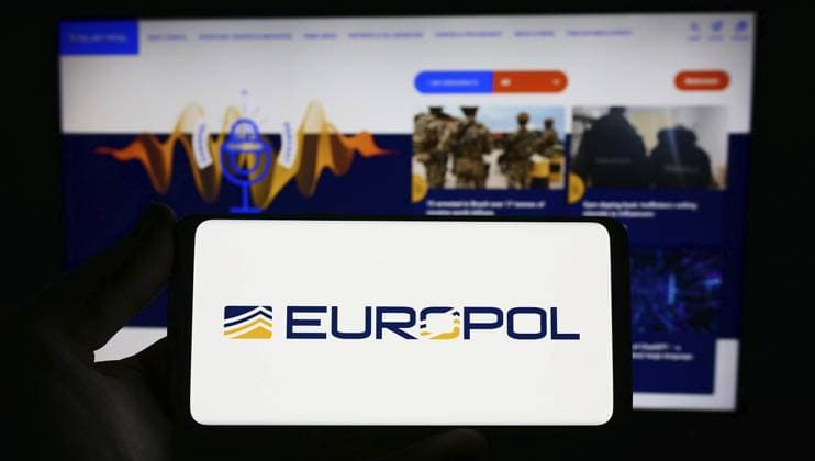 Stuttgart, Germany, 04-02-2023: Person holding smartphone with logo of EU law enforcement agency Europol on screen in front of website. Focus on phone display, Europe *** Stuttgart, Germany, 04 02 2023 Person Holding Smartphone With Logo of EU Law Enforcement Agency Europol ON Screen in Front of Website Focus ON Phone display, Europe Copyright: imageBROKER TimonxSchneider ibliqx10709350.jpg