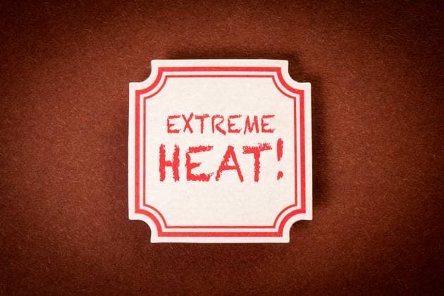 Extreme Heat. Sticky note with text on a brown textured background. Copyright: xEdgarsxSermulisx