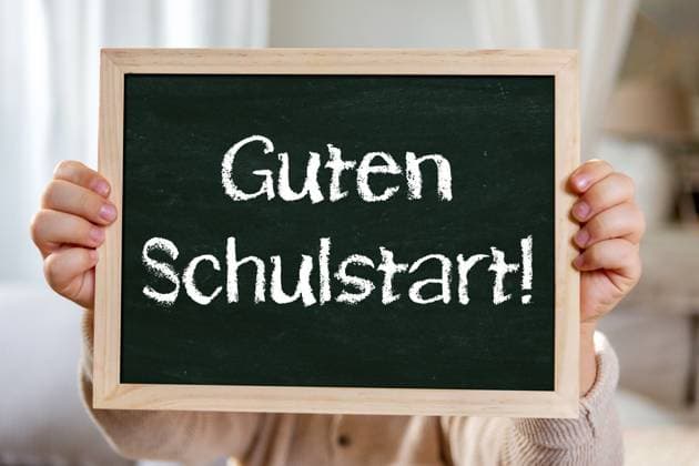 2 August 2024: Happy school start! Congratulations on starting school. Child holding chalkboard with inscription: Good start to school. PHOTOMONTAGE *** Guten Schulstart! Glückwünsch zur Einschulung. Kind hält Kreidetafel mit Aufschrift: Guten Schulstart. FOTOMONTAGE