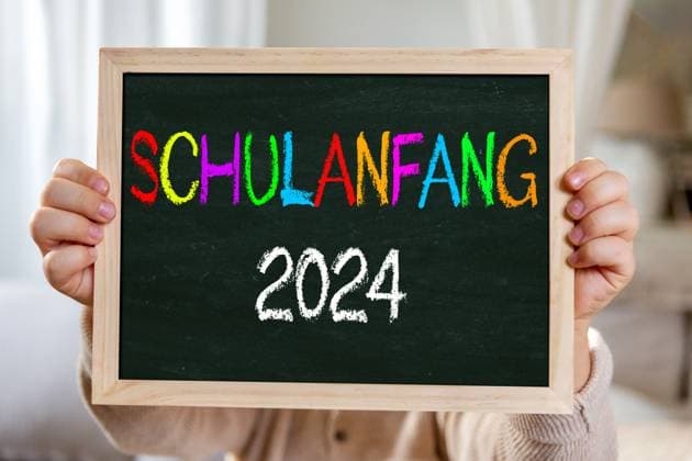 2 August 2024: Start of school 2024, blackboard in the hand of a child with the inscription: Start of school 2024. PHOTO ASSEMBLY *** Schulanfang 2024, Tafel in der Hand von einem Kind mit Aufschrift: Schulanfang 2024. FOTOMONTAGE