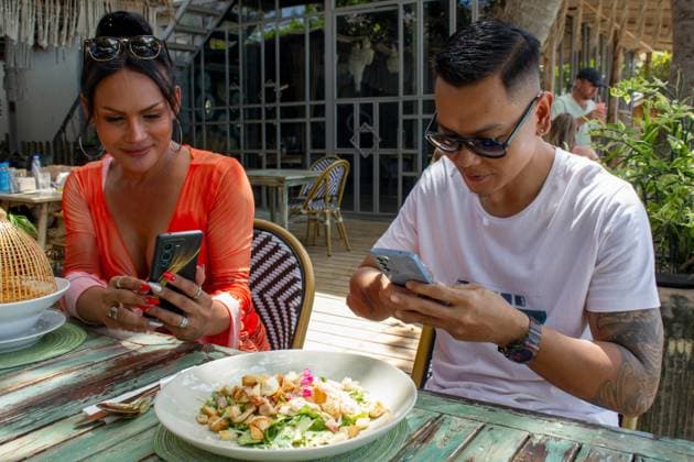 Foodie friends photographing food in restaurant model released Copyright: xLaurenxFowlerx