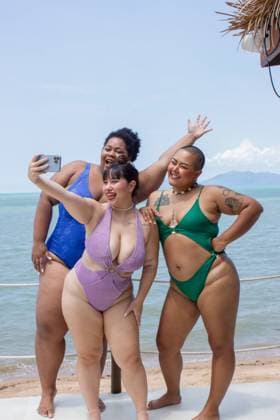 Group of cheerful women taking selfie on beach model released Copyright: xLaurenxFowlerx