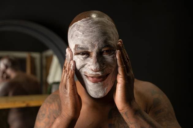 Man applying face mask in bathroom model released Copyright: xCulturaxCreativex