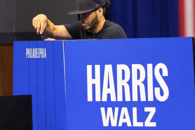Workers install new campaign signs prior to U.S. Vice President, and Democratic presidential candidate, Kamala Harris announceing Minnesota Governor Tim Walz as her running mate in Philadelphia, Pennsylvania on Tuesday, August 6, 2024.  PHI20240806001 LaurencexKesterston