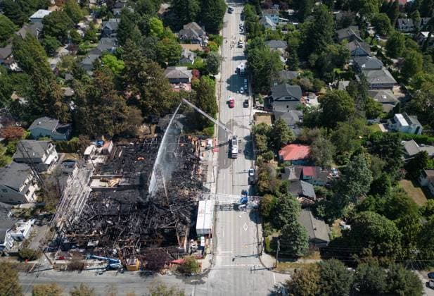 August 7, 2024, Vancouver, Bc, CANADA: A crane that collapsed during a fire at an apartment building under construction on Tuesday lies across the road, as firefighters direct water on the remains of the structure in Vancouver, on Wednesday, August 7, 2024. The fire destroyed the building under construction and damaged nine other nearby homes. Vancouver CANADA  - ZUMAc35_ 20240807_zaf_c35_157 Copyright: xDarrylxDyckx