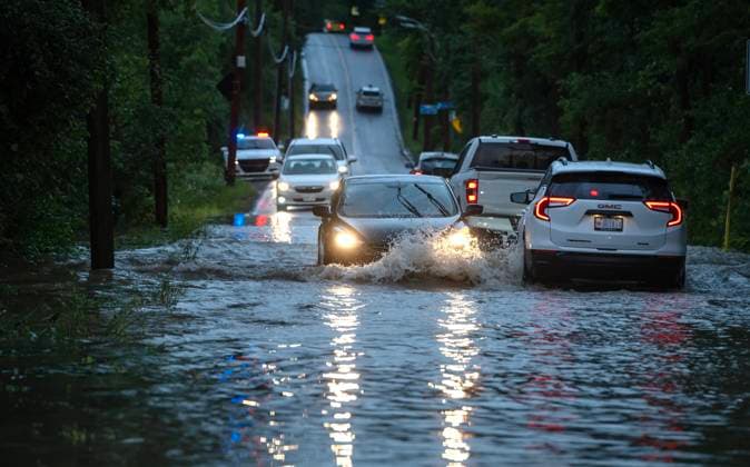 August 9, 2024, Montreal, Pq, CANADA: Cars drive slowly through flooded streets in Sainte-Anne-de-Bellevue on the Island of Montreal after heavy rains hit the area on Friday, August 9, 2024. Montreal CANADA  - ZUMAc35_ 20240809_zaf_c35_173 Copyright: xPeterxMccabex