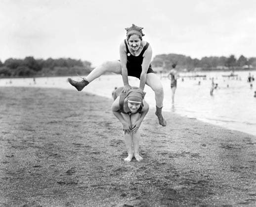 Two Young Women playing Leap Frog on Beach, USA, National Photo Company, 1921  Copyright: xCircaxImagesx ghi-circa02328