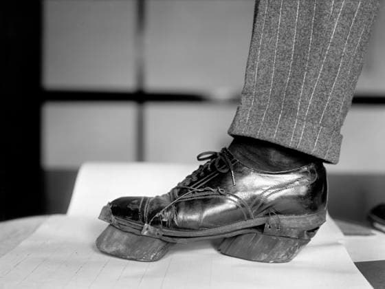 Policeman trying on Cow Shoe used by Moonshiners during Prohibition, Washington DC, USA, National Photo Company, June 1924  Copyright: xCircaxImagesx ghi-circa02661