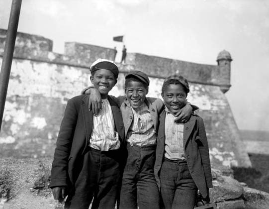 Portrait of three smiling boys with Fort Matanzas in background, Happy as the Day is Long , near St. Augustine, Florida, USA, William Henry Jackson for Detroit Publishing Company, 1902  Copyright: xCircaxImagesx ghi-circa03733