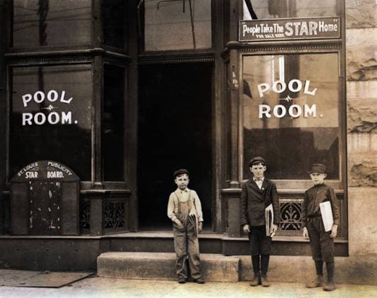 Three young newsboys standing outside pool hall after receiving afternoon newspapers, boys were smoking and playing pool while waiting for papers, youngest boy is 9 years old and sells until 9:00 p.m., Chouteau and Manchester Streets, St. Louis, Missouri, USA, Lewis Hine for National Child Labor Committee, May 1910  Copyright: xCircaxImagesx ghi-circa04355