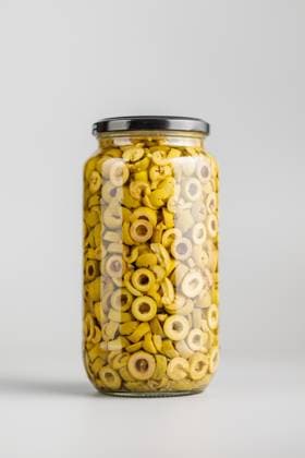 Sliced pickled green olives in brine in jar on gray background. Sliced pickled green olives in brine in jar on a gray background. Copyright: xZoonar.com JirixHERAx 22015852