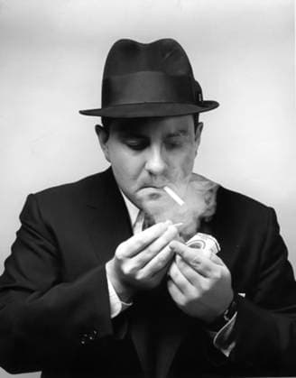 Mid-adult man in suit and hat lighting a cigarette  Copyright: xStephenxSheffieldx ghi-steps00512