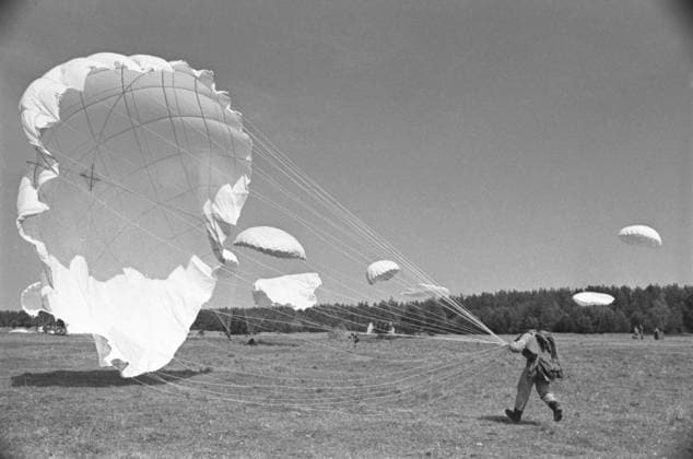 Training jumps of Ryazan Airborne Forces School cadets 8746045 01.09.1969 Lenin Komsomol Ryazan Higher Airborne Command Red Banner School (now General Margelov Ryazan Guards Higher Airborne Command School). Training jumps of paratroopers from airplanes. Landing in a designated area. Ryazan region Russia  Copyright: xx
