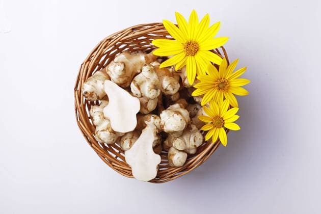 Jerusalem artichoke (Sunchok) on a white background, artichoke with yellow flowers, top view Jerusalem artichoke (Sunchok) on a white background, artichoke with yellow flowers, top view. High quality photo Copyright: xZoonar.com EmmaBoykox 22045328