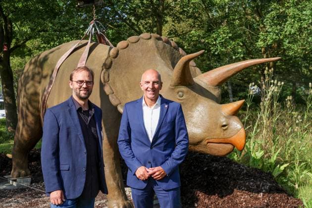Wenn schwere Dinos fliegen - Modelle vor dem LWL-Museum für Naturkunde versetzt. Wahrzeichen des Museums kennzeichnen neuen Museumseingang. Das LWL-Museum für Naturkunde bekommt einen Anbau auf dem Museumsvorplatz. Dr. Georg Lunemann, Direktor des Landschaftsband Westfalen-Lippe (re.) und Dr. Jan Ole Kriegs, Museumsdirektor. Münster, Nordrhein-Westfalen, DEU, Deutschland, 22.08.2024