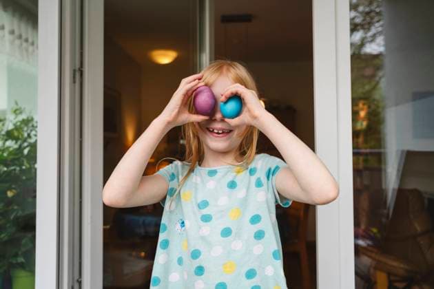 Happy girl covering eyes with easter eggs at home model released, Symbolfoto property released, IHF02078