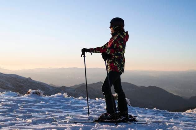 Woman in warm clothing standing on ski pole under clear sky model released, Symbolfoto, LMCF01387