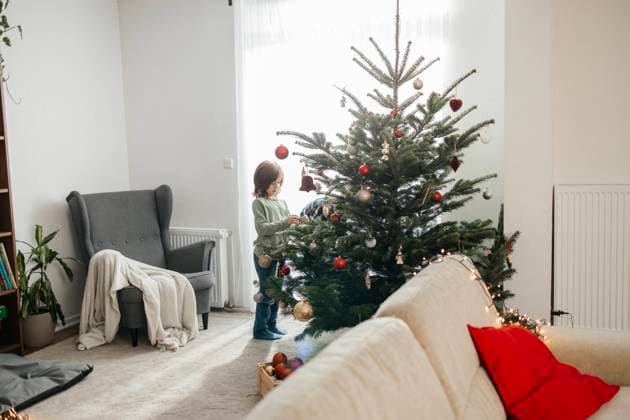 Cute boy decorating Christmas tree at home model released, Symbolfoto property released, ELMF00627