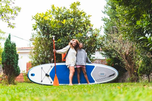 Mature woman and granddaughter with paddle board in back yard model released, Symbolfoto, JAQF01583
