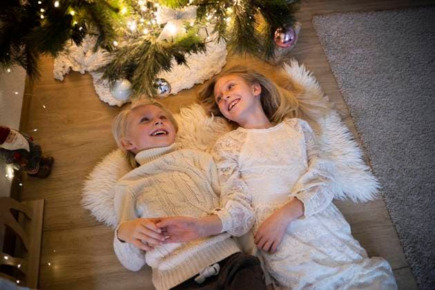 Happy children lying down and enjoying leisure time during Christmas at home model released, Symbolfoto property released, NJAF01292