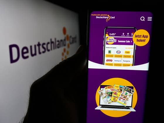 Person holding smartphone with webpage of German customer loyalty company DeutschlandCard GmbH. Stuttgart, Germany - 07-15-2024: Person holding smartphone with webpage of German customer loyalty company DeutschlandCard GmbH in front of logo. Focus on center of phone display. Copyright: xZoonar.com TimonxSchneiderx 22090969