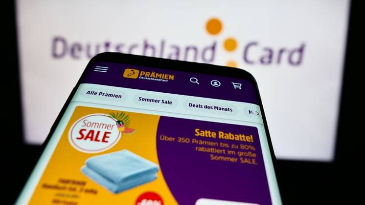 Mobile phone with website of German customer loyalty company DeutschlandCard GmbH in front of logo. Stuttgart, Germany - 07-15-2024: Mobile phone with website of German customer loyalty company DeutschlandCard GmbH in front of business logo. Focus on top-left of phone display. Copyright: xZoonar.com TimonxSchneiderx 22090972