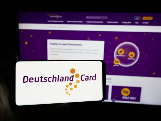Person holding smartphone with logo of German customer loyalty company DeutschlandCard GmbH. Stuttgart, Germany - 07-15-2024: Person holding smartphone with logo of German customer loyalty company DeutschlandCard GmbH in front of website. Focus on phone display. Copyright: xZoonar.com TimonxSchneiderx 22090984
