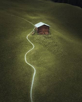 A cozy wooden cabin secluded in the Swiss Alps, accessible by a winding path through a lush green meadow. Model Released Ca_maraphy_ID23343_678643_005 Copyright: xCAxMARAPHYx RECORD DATE NOT STATED